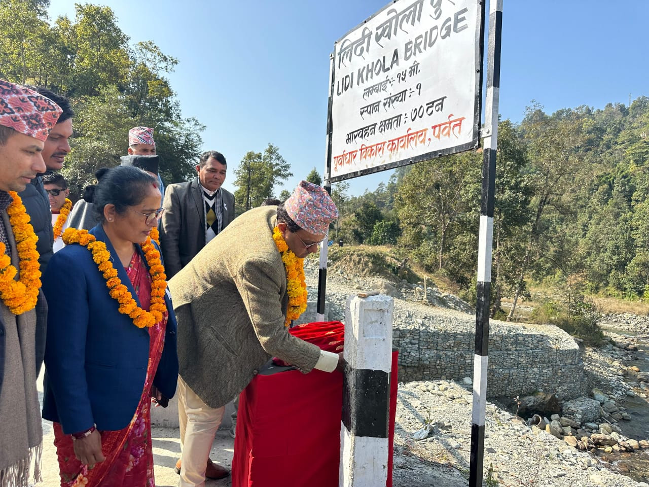 Honorable Minister Prakash Bahadur KC inaugurating the Lidi river bridge which has been completed in Parbat's Modi Rural Municipality.